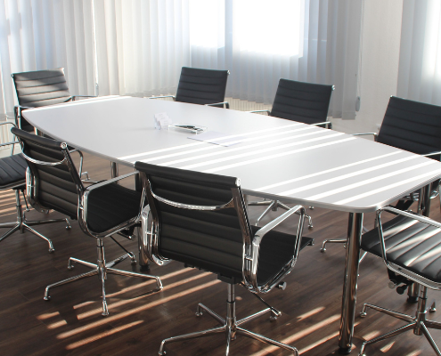Meeting room table with chairs around it