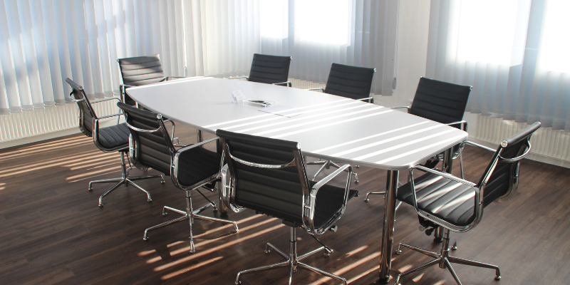 Meeting room table with chairs around it