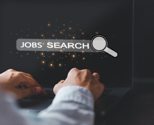 Hands of a business person typing on a laptop that reads Job Search
